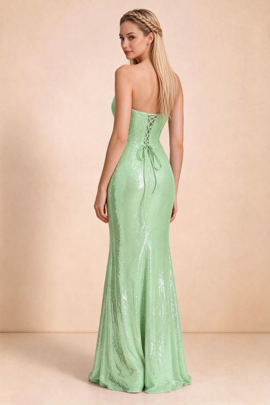 Rear three-quarter studio view of Calista light green dress showing the centre-back lacing and long skirt