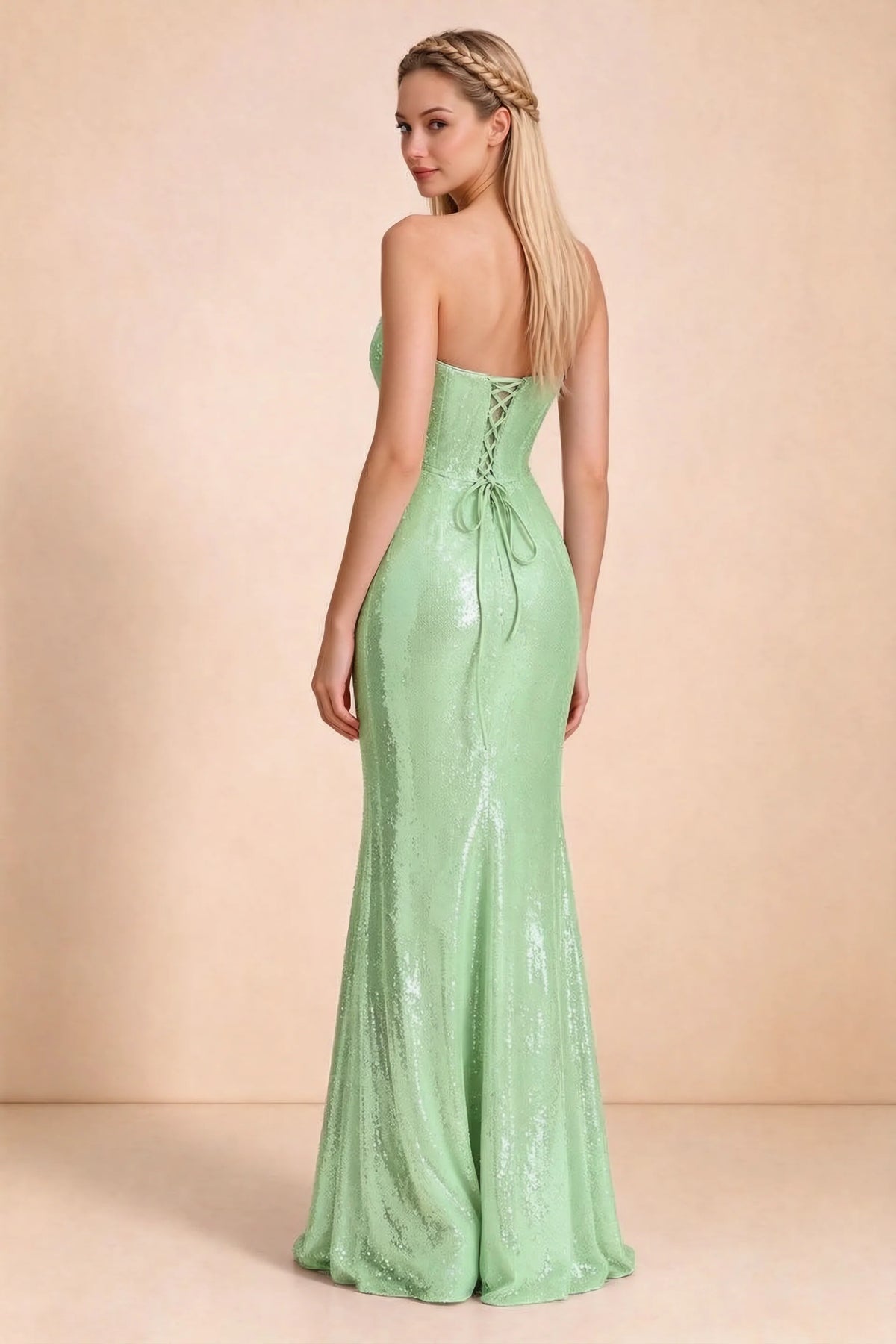 Rear three-quarter studio view of Calista light green dress showing the centre-back lacing and long skirt