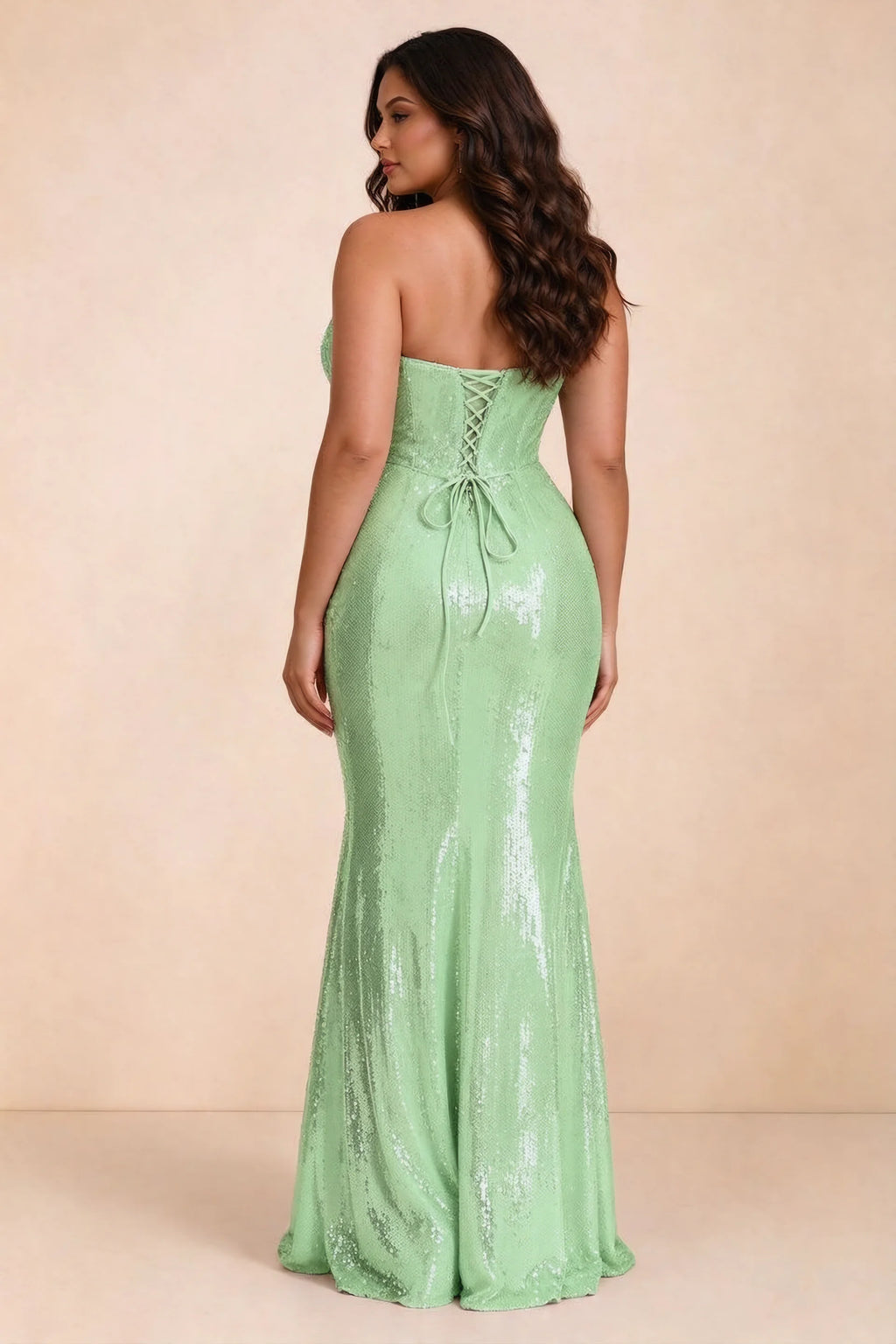 Rear studio view of Calista light green dress on a second model, showing the back lacing and sequin skirt