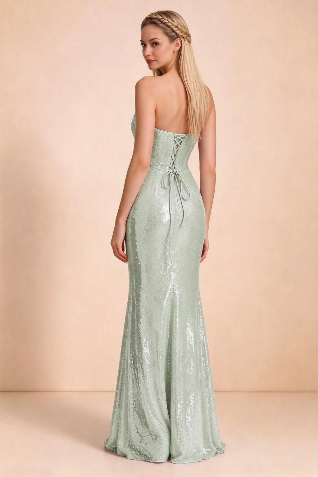 Rear three-quarter studio view of Calista sage green dress showing the centre-back lacing and long skirt