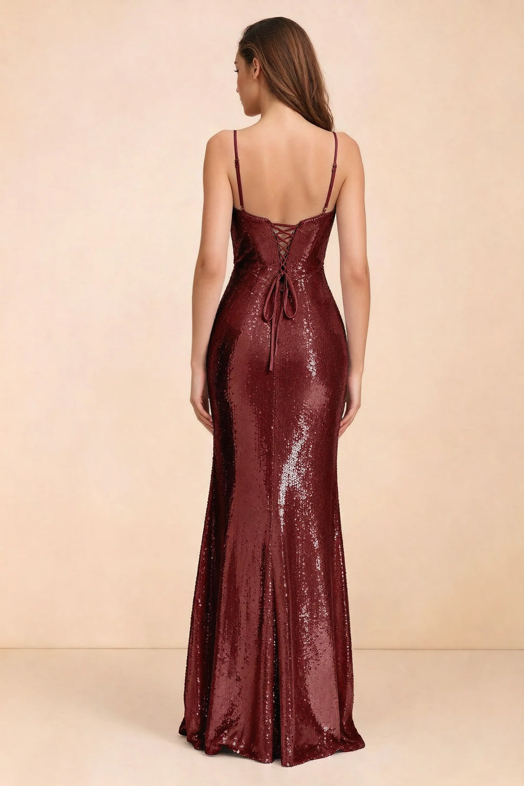 Rear three-quarter studio view of Callie burgundy dress showing the centre-back lacing and mermaid skirt