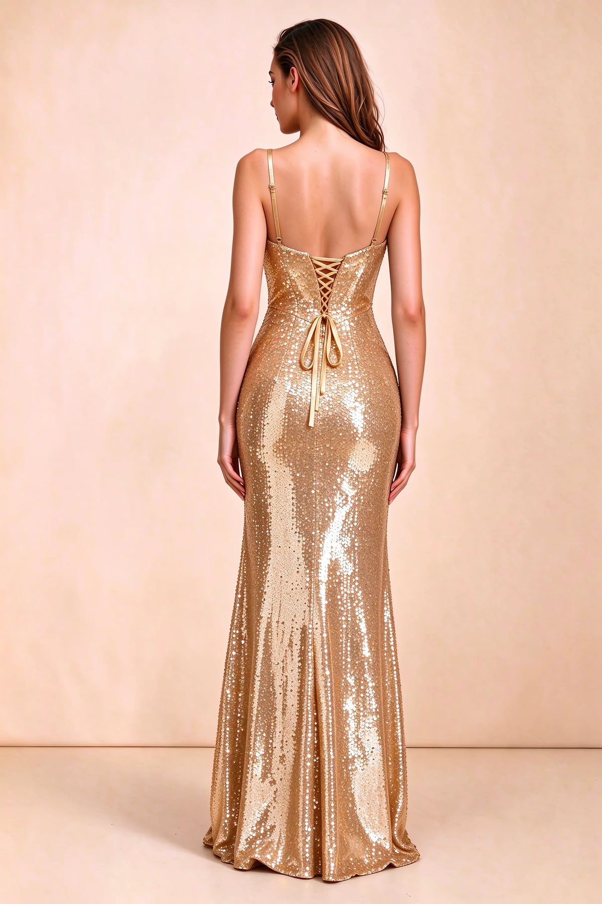 Rear three-quarter studio view of Callie gold dress showing the centre-back lacing and mermaid skirt