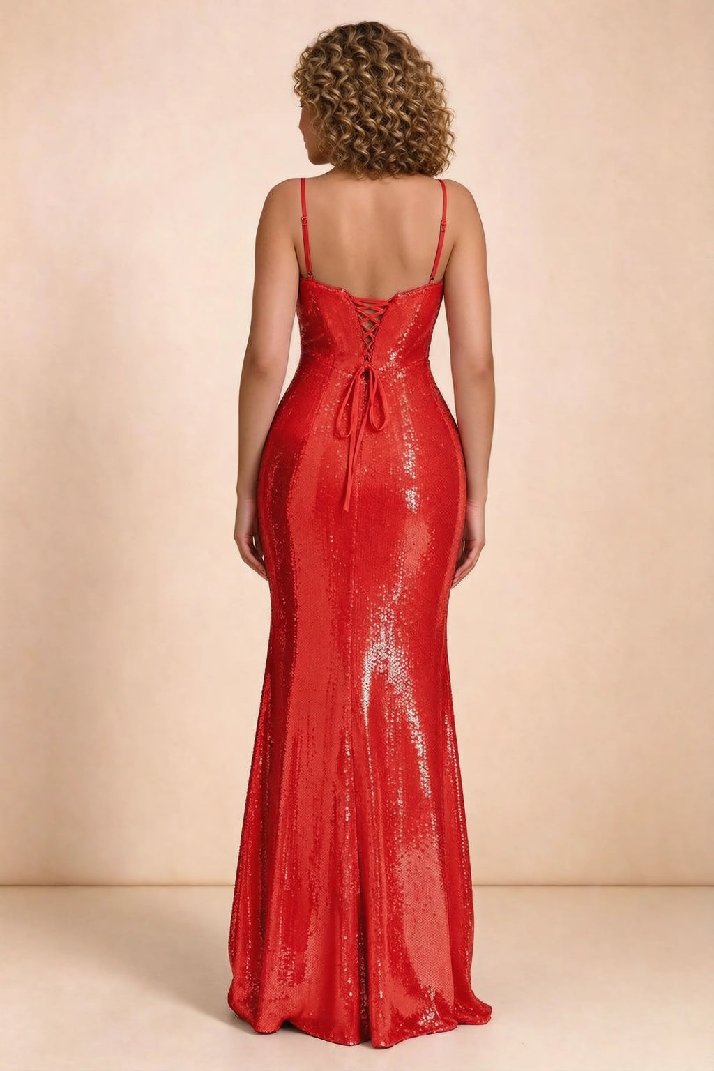 Rear studio view of Callie red dress on a second model, showing the back lacing and sequin skirt