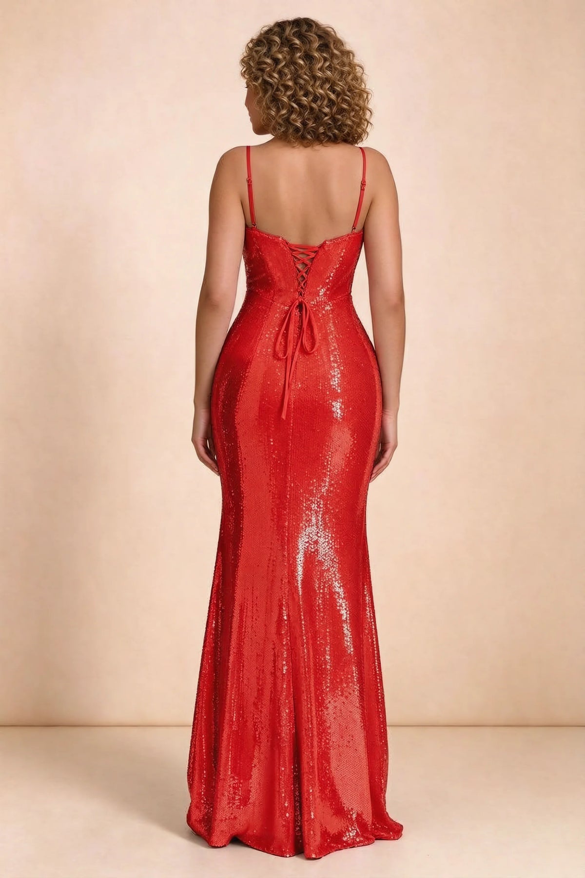 Rear studio view of Callie red dress on a second model, showing the back lacing and sequin skirt