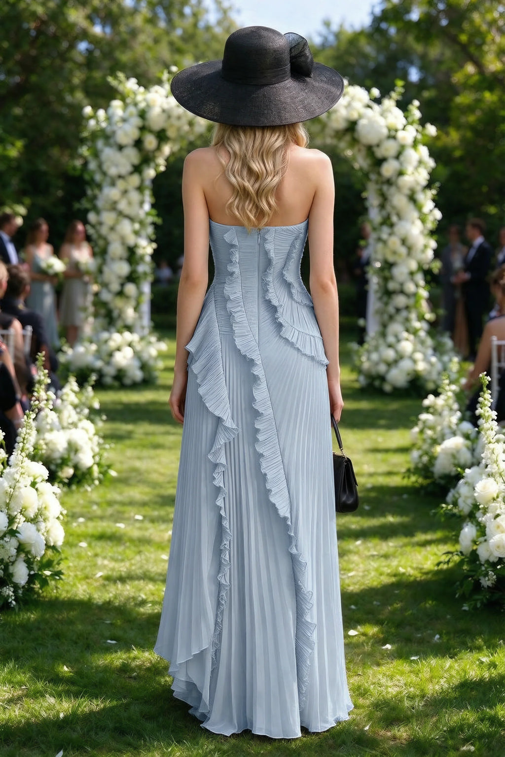 Outdoor rear view of Camilla dusty blue dress showing the layered ruffles and long back hem