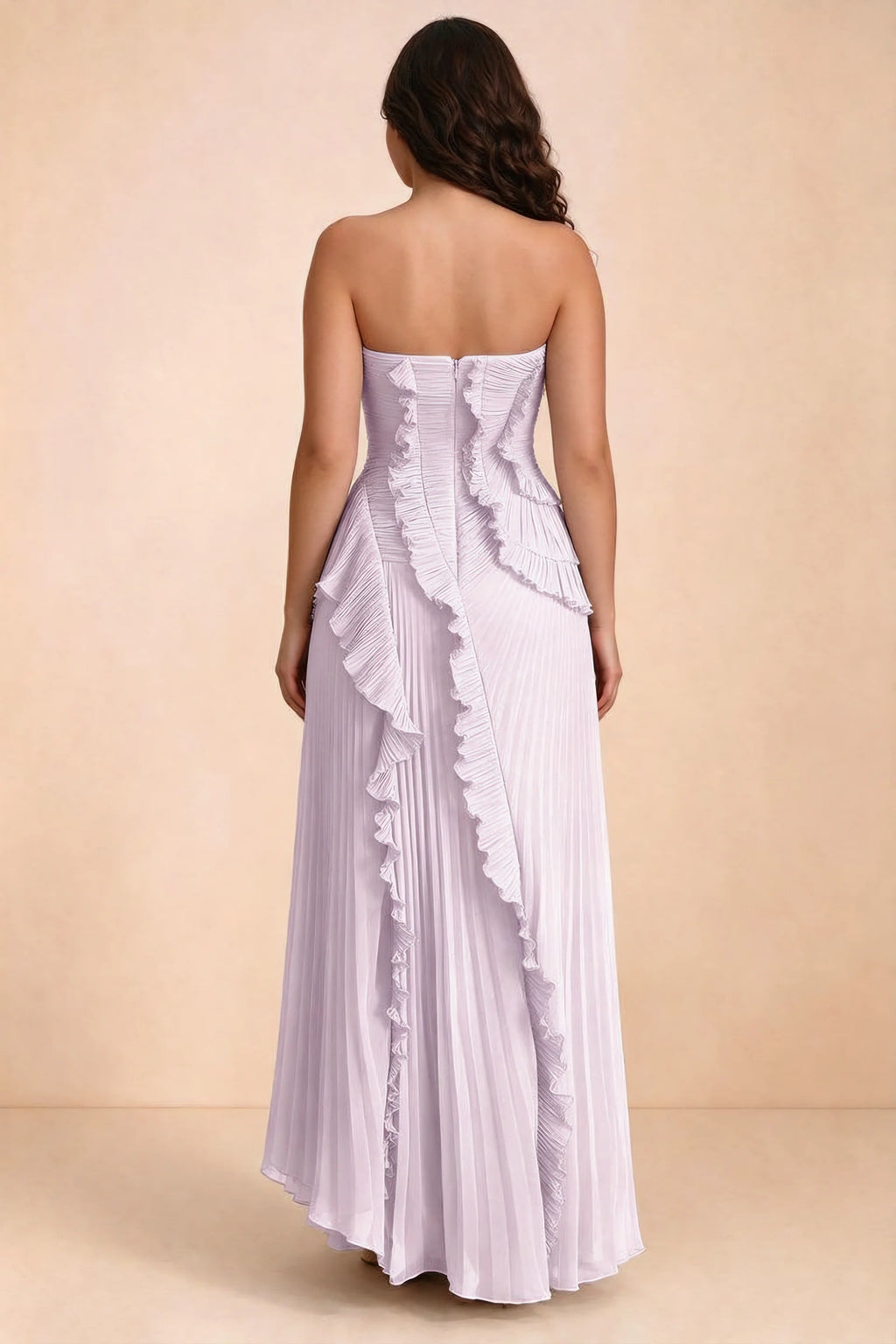 Rear studio view of Camilla lilac dress on a second model, showing the ruffled back and pleated skirt
