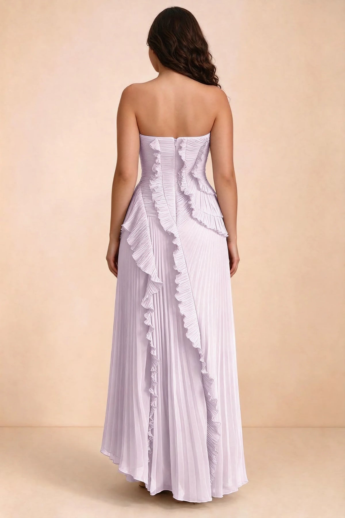 Rear studio view of Camilla lilac dress on a second model, showing the ruffled back and pleated skirt