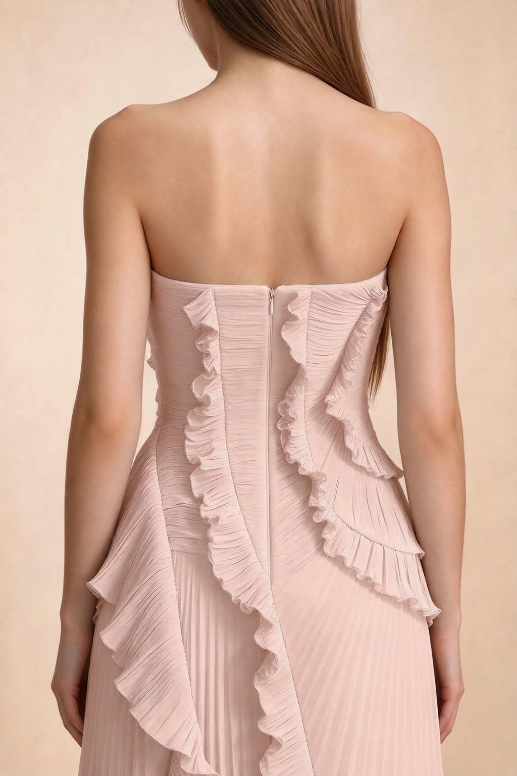 Close-up of Camilla haze pink back bodice, centre-back zipper and curved ruffle edges