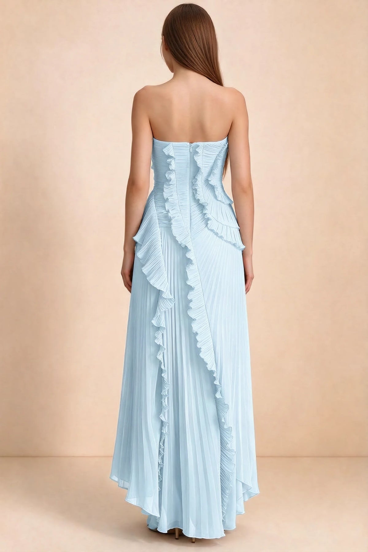 Rear studio view of Camilla sky blue dress showing curved ruffle layers and a long pleated skirt