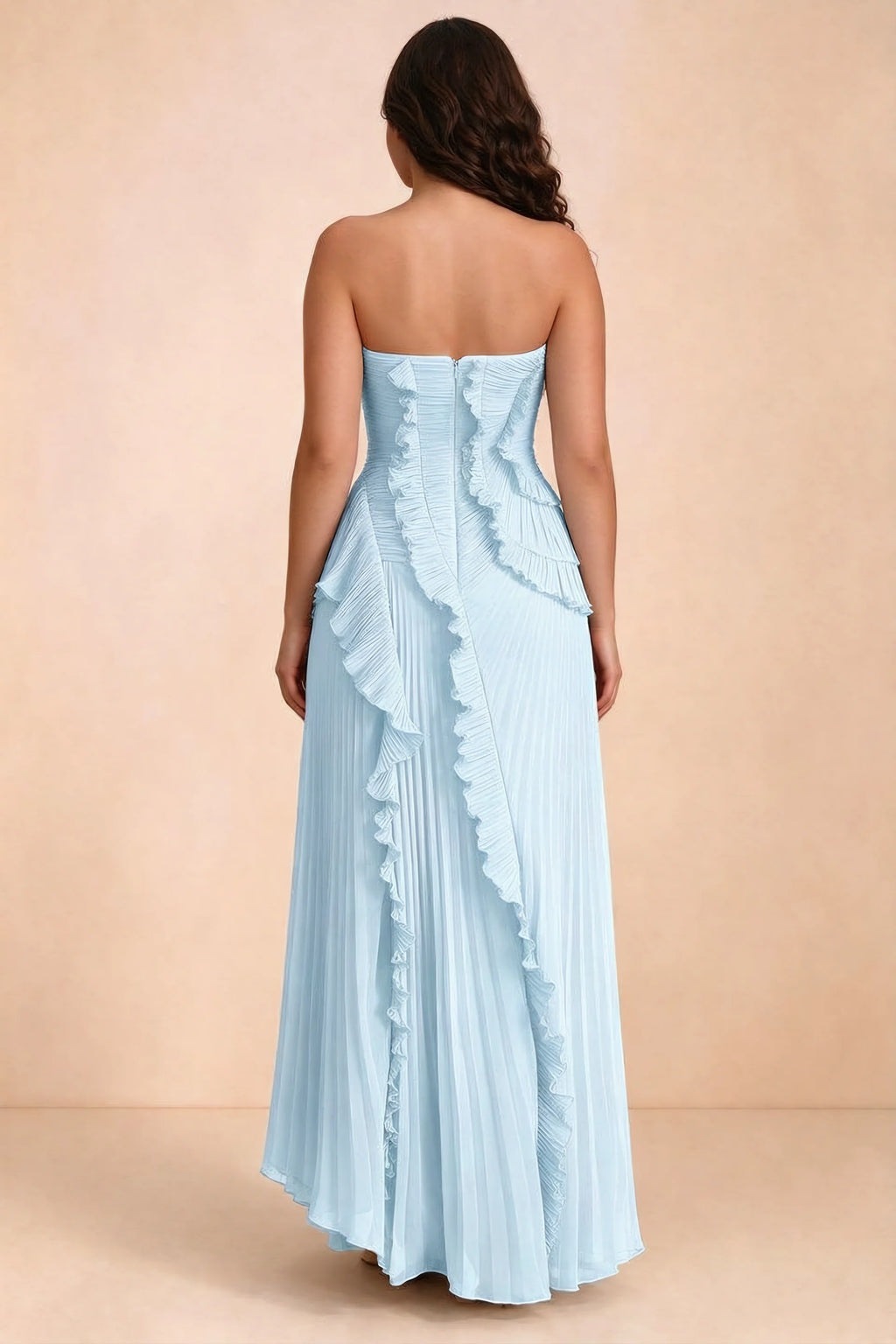 Rear studio view of Camilla sky blue dress on a second model, showing the ruffled back and pleated skirt