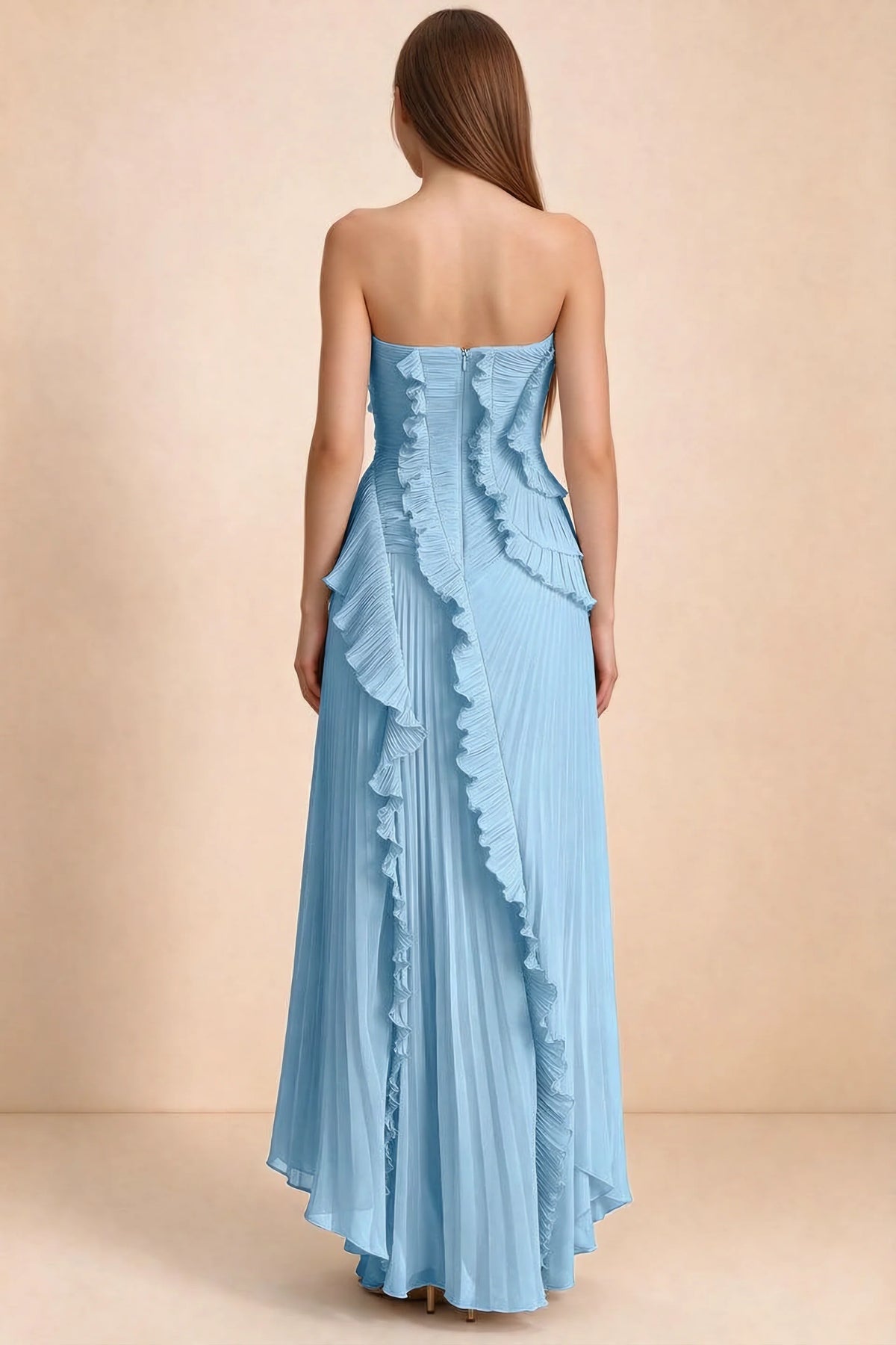 Rear studio view of Camilla steel blue dress showing curved ruffle layers and a long pleated skirt