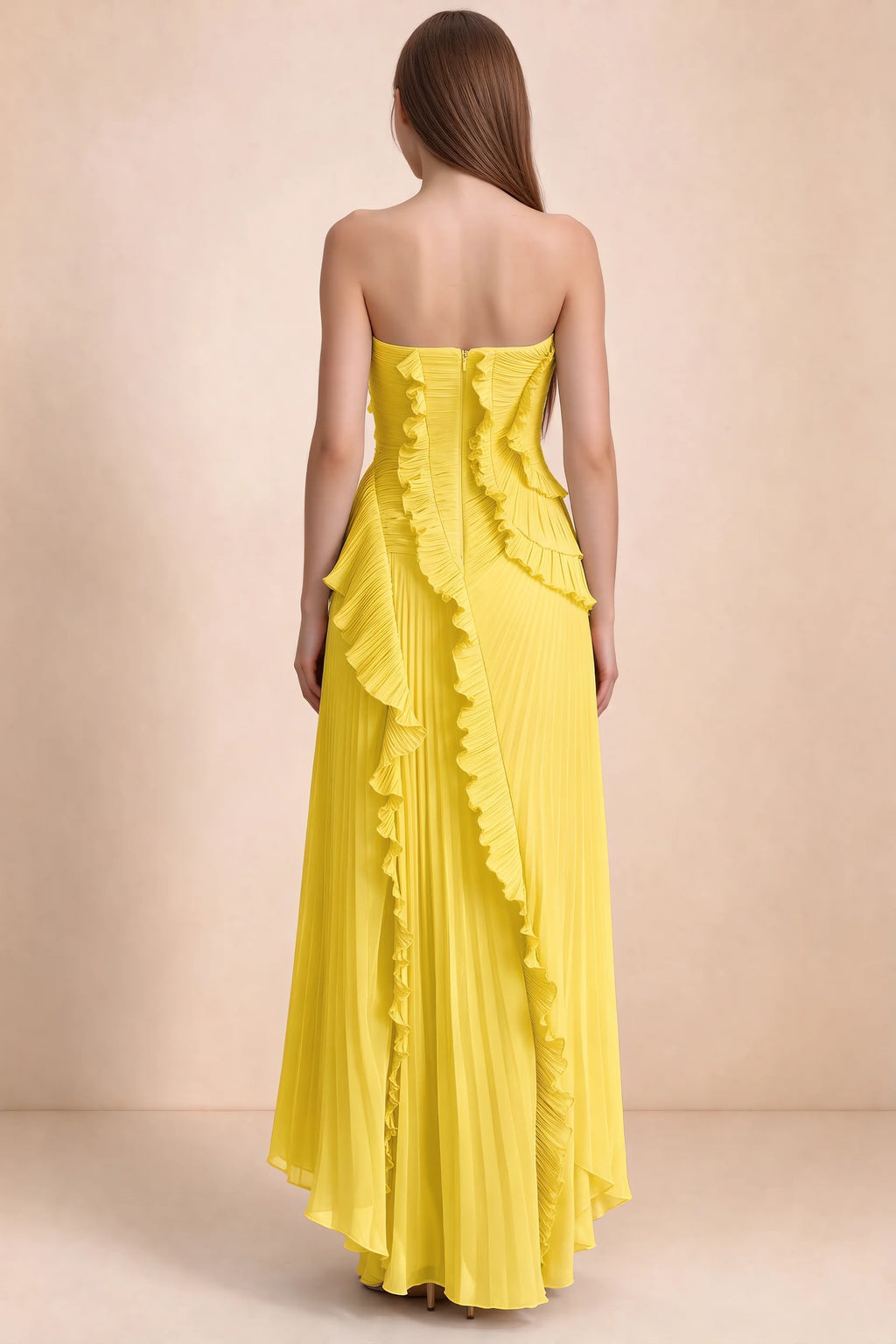 Rear studio view of Camilla yellow dress showing curved ruffle layers and a long pleated skirt