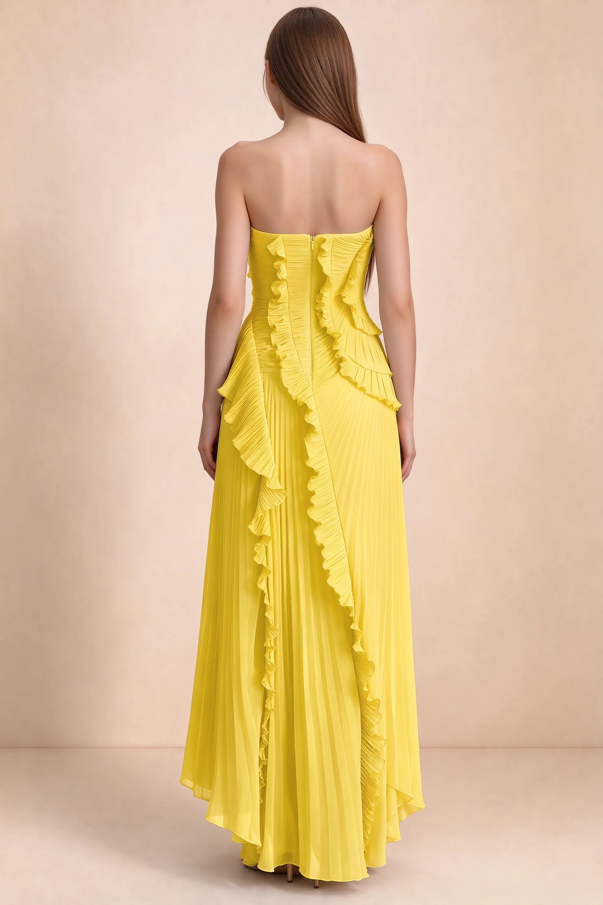 Rear studio view of Camilla yellow dress showing curved ruffle layers and a long pleated skirt