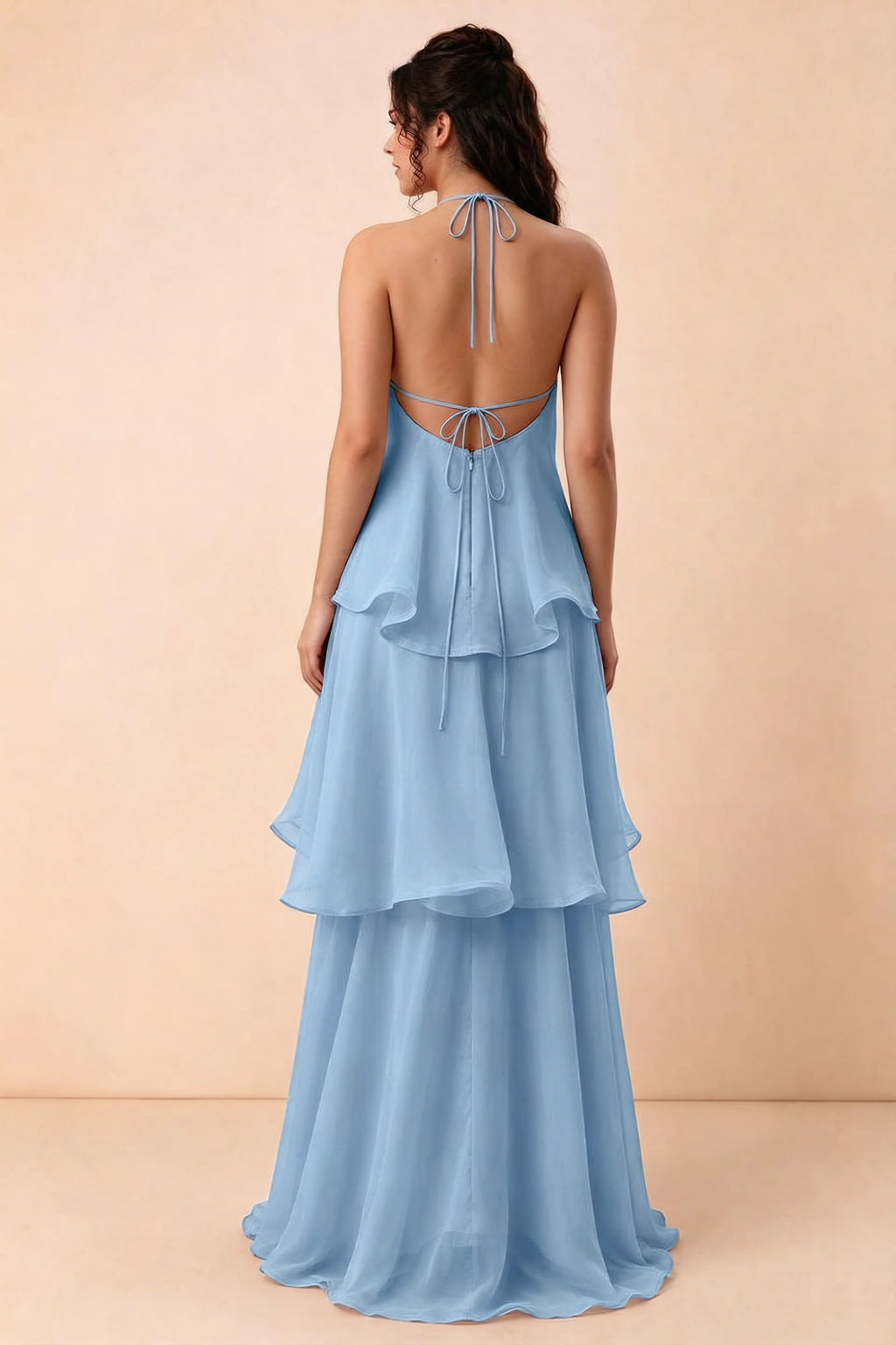 Rear studio view of Candace steel blue dress showing the low open back and long layered skirt