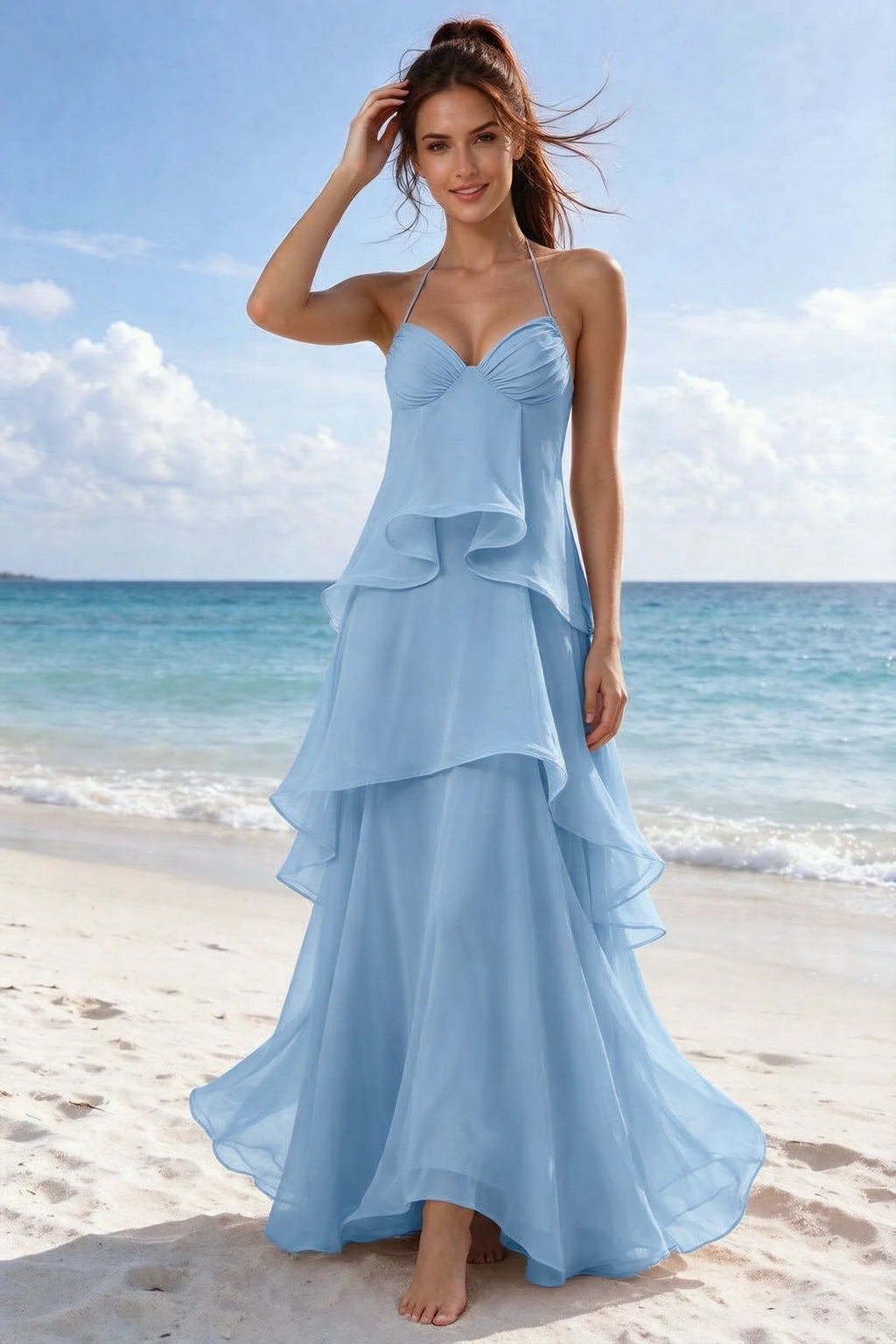 Beachside front view of Candace steel blue halter dress showing the flowing ruffles and flared hem