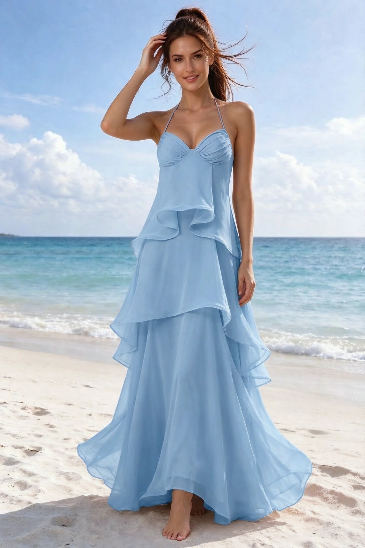 Beachside front view of Candace steel blue halter dress showing the flowing ruffles and flared hem