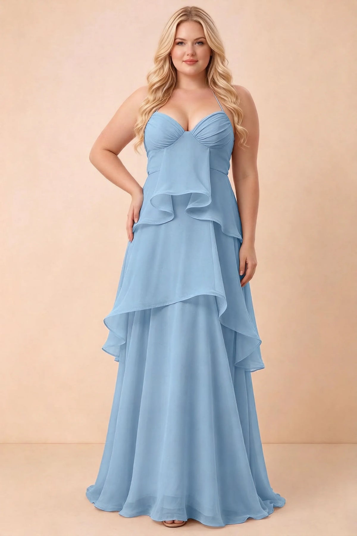 Front studio view of Candace steel blue dress on a second model, showing the gathered bust and broad ruffles