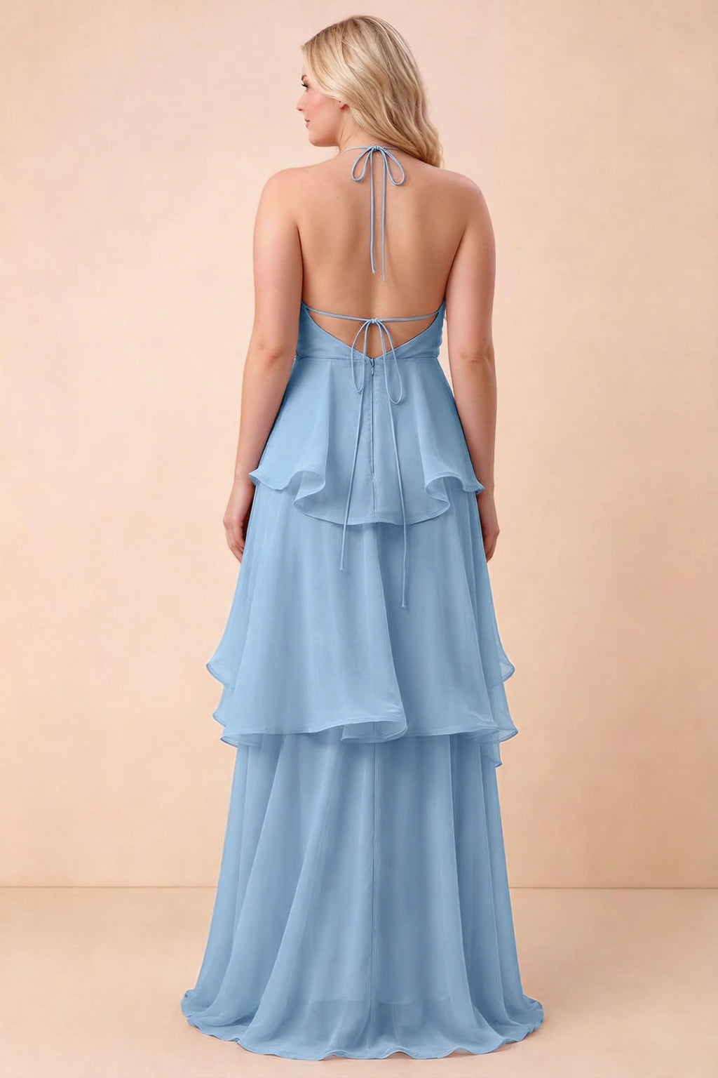 Rear studio view of Candace steel blue dress on a second model, showing the open back and long hem