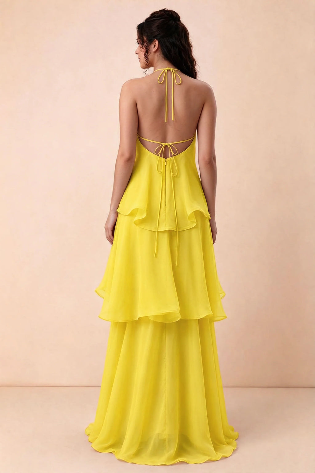 Rear studio view of Candace yellow dress showing the low open back and long layered skirt