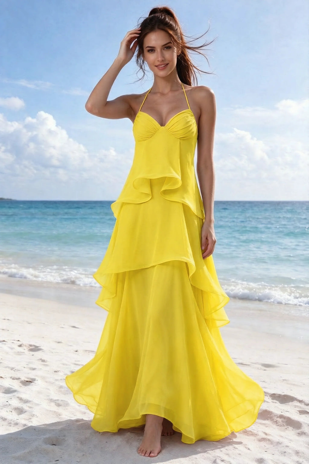 Beachside front view of Candace yellow halter dress showing the flowing ruffles and flared hem