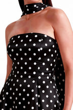 Fabric texture close up of LVLVS Candice black polka dot crepe dress showcasing smooth material and stylish halter neck scarf design