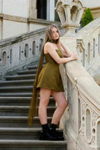 Plus Size Model in LVLVS Candice Olive Crepe Dress Leaning on Stairs for City Street Style Lookbook
