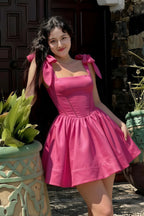 Asian woman wearing LVLVS Cassandra hot pink bow strap skater dress for outdoor brunch and casual going out