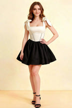 LVLVS Cassandra white and black stretch crepe mini skater dress with square neckline and bow straps for cocktail party