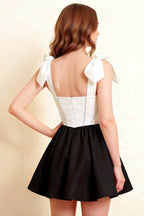 Model back view showcasing LVLVS Cassandra white and black bow straps dress perfect for formal party