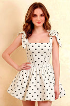 Close up fit and flare silhouette of LVLVS Cassandra white polka dot stretch crepe dress for semi-formal party wear