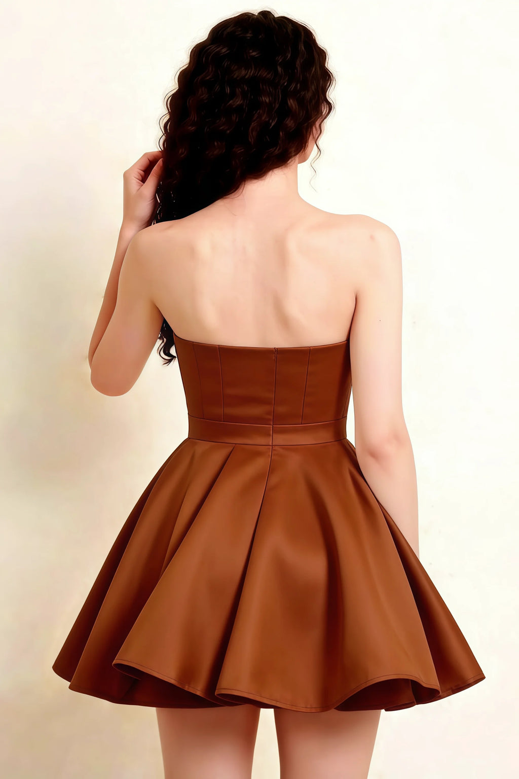 Cropped back view of LVLVS chocolate Catherine bandeau dress highlighting tailored waist seam and structured peplum, sophisticated semi-formal attire.