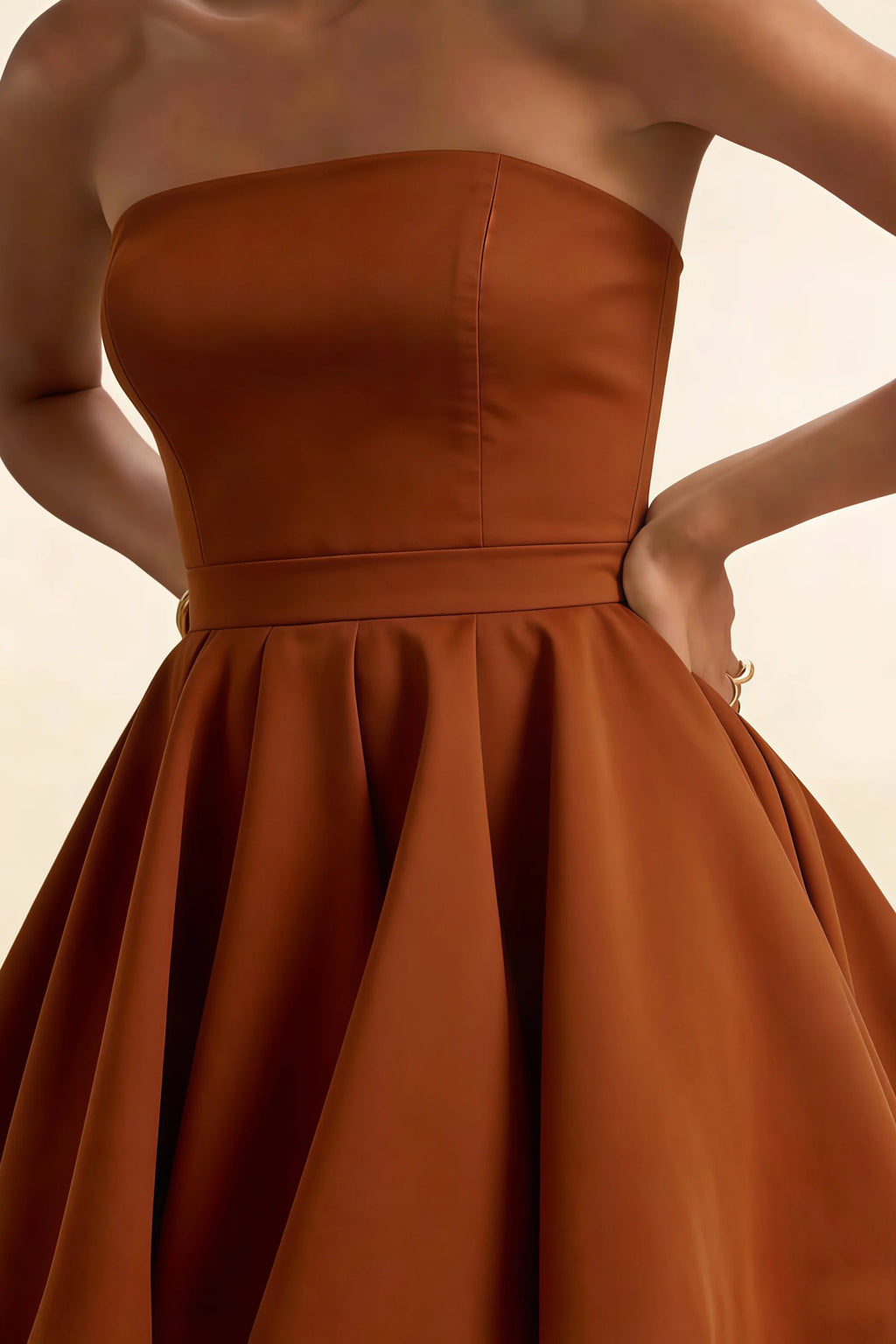 Detailed close up of LVLVS chocolate Catherine dress waistband and bonded crepe fabric, smooth bandeau construction for elegant bridesmaid or wedding guest dress.