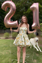 Customer in LVLVS Catherine Green and White Floral Print Bandeau Ruffle Mini Dress for 21st Birthday Party with Balloons and Dog