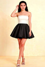 Elegant woman wearing LVLVS White and Black bonded crepe Catherine bandeau ruffle mini dress in a studio setting, perfect for cocktail parties and bridal shower events.
