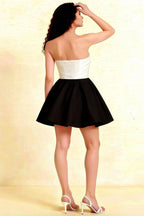 Back view of the LVLVS Catherine white and black bandeau dress showcasing a sleek zipper closure, ideal for formal parties and evening social gatherings.