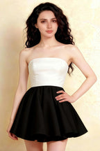 Close-up studio shot of the LVLVS Catherine white and black bandeau dress highlighting the sweetheart neckline and flirty ruffle mini skirt silhouette.