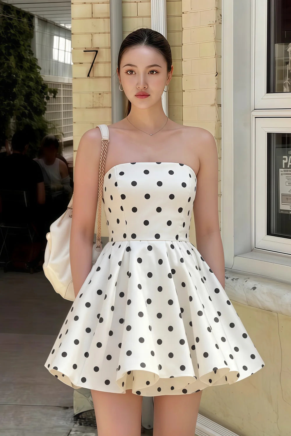 Customer wearing LVLVS White Polka Dot Catherine Bandeau Ruffle Mini Dress for brunch and casual outings, stylish real-life look on the street.