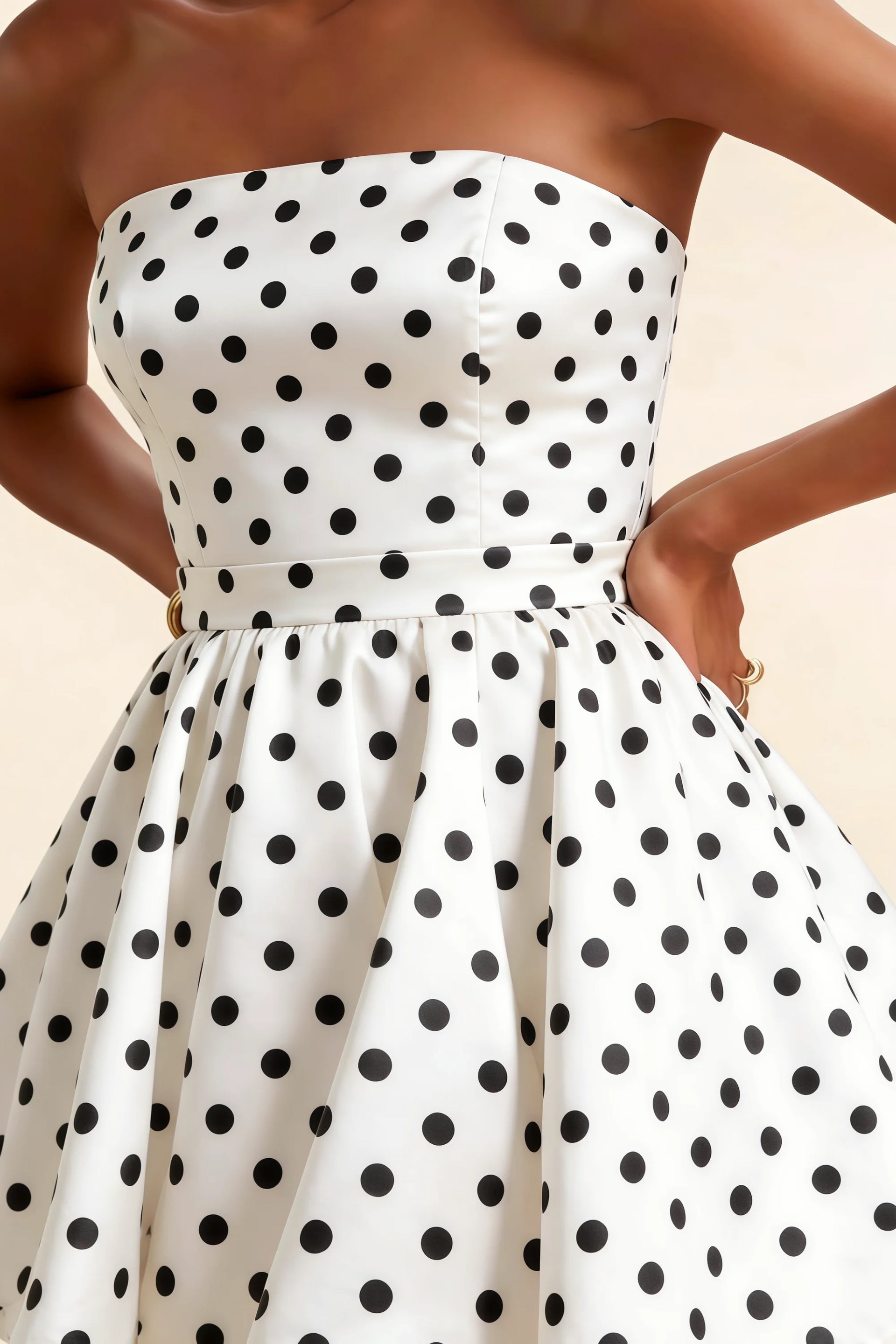 Detailed close-up of the LVLVS Catherine white polka dot bandeau ruffle mini dress emphasizing the textured bonded crepe fabric and gathered waist detail for office work.
