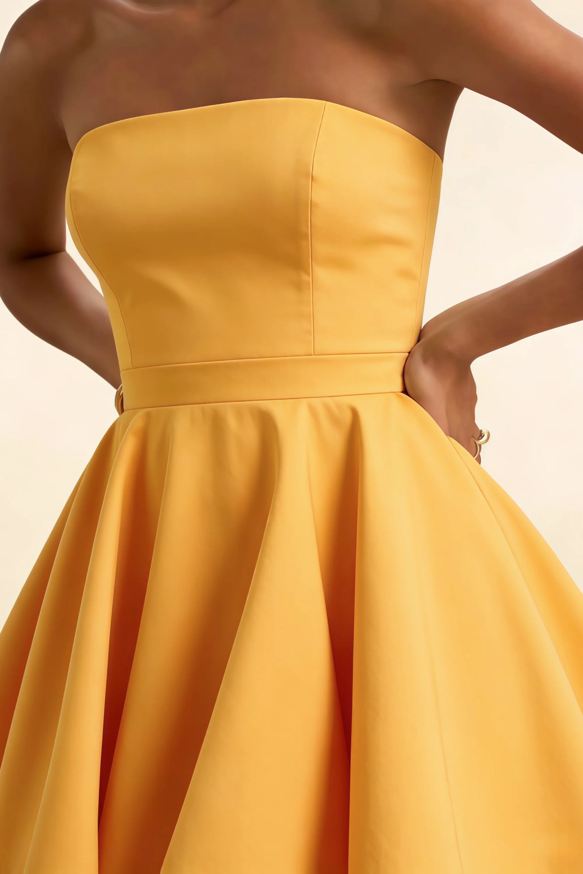 Close up of yellow strapless Catherine dress bodice in bonded crepe for wedding guest and formal dinners