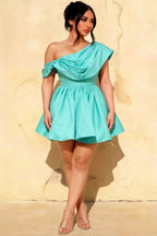 Plus size model wearing LVLVS Cecilia aqua one shoulder skater dress for inclusive wedding guest and party wear