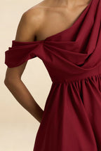Detailed Fabric Closeup of LVLVS Burgundy Crepe Dress Highlighting the Stretchy Draped One Shoulder Design for Office Work and Daytime Events