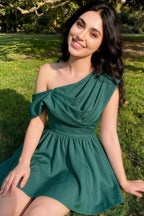 Real customer photo of the LVLVS Cecilia crepe dress in peacock color, styled for a casual garden party, featuring flattering one shoulder draping and flowy skirt.