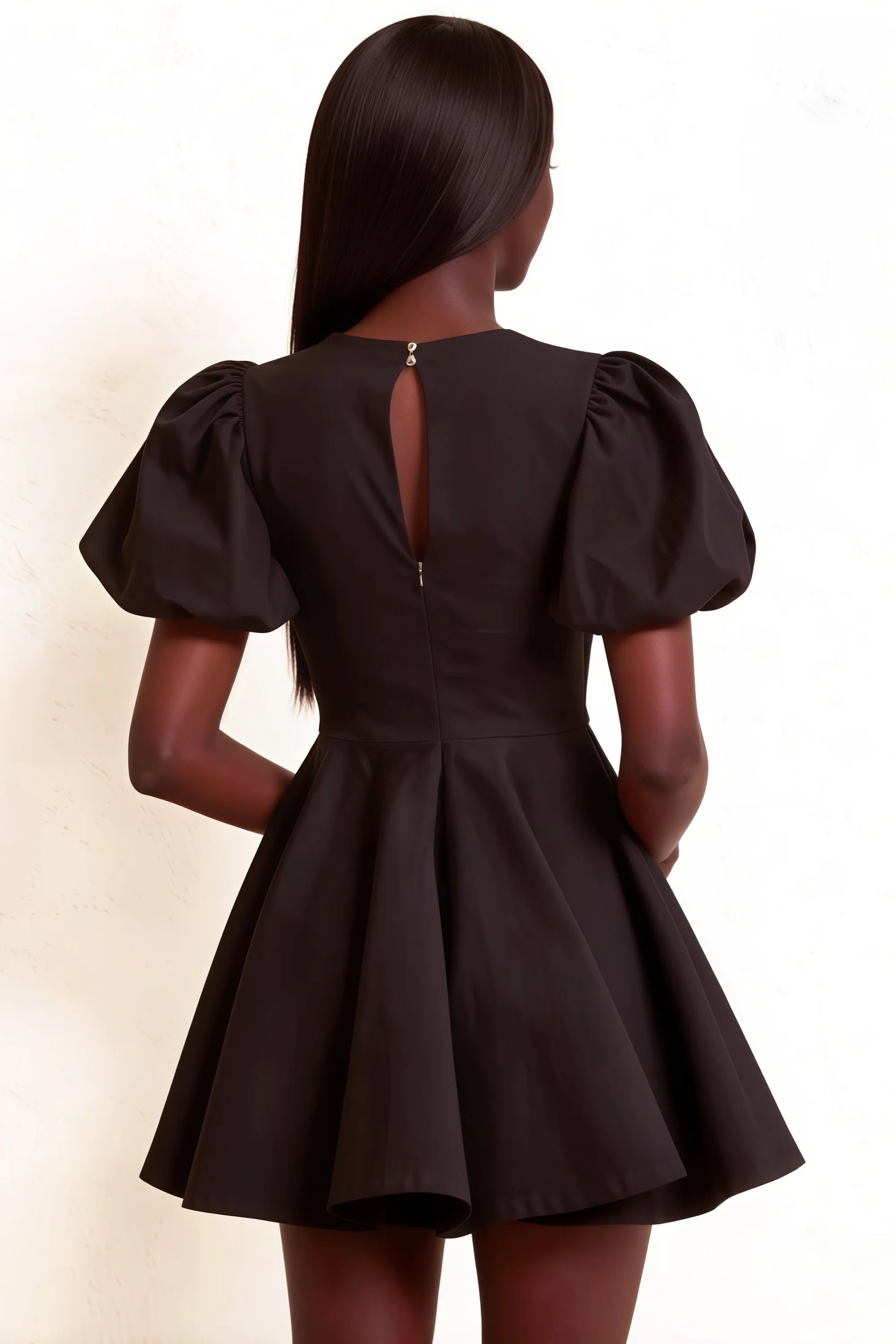 Elegant back detail of LVLVS Celia black puff sleeve dress showcasing the open back and zipper closure