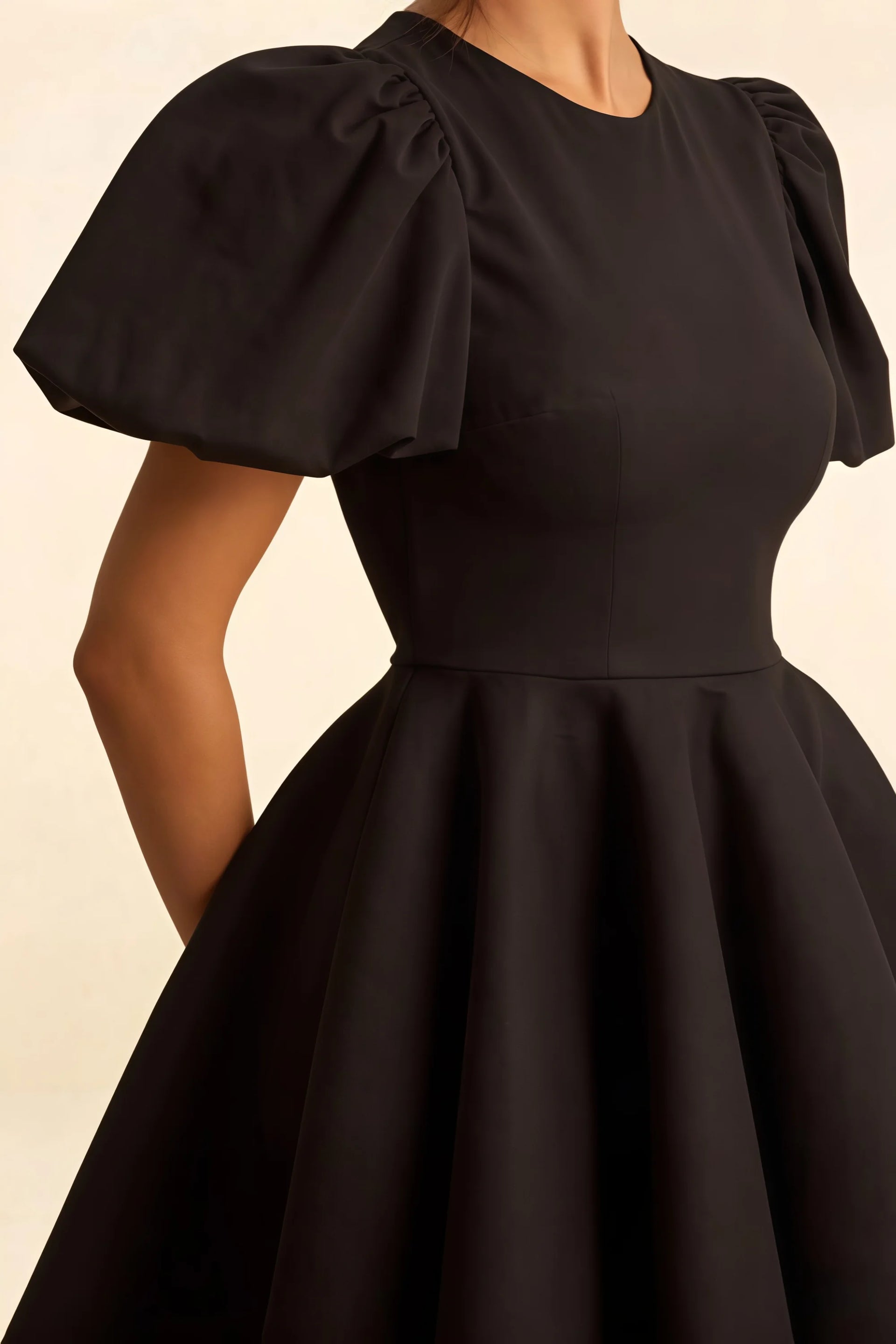 Luxury stretch crepe fabric texture of LVLVS Celia black dress with gathered puff short sleeves detail