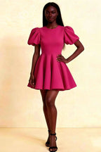 LVLVS Celia dress in Hot Pink stretch crepe, featuring puff sleeves and a flared mini skirt, styled for cocktail party or bridesmaid wear.