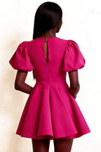 Rear view close-up of the LVLVS Celia hot pink mini dress, focusing on the back zipper and elegant puffed short sleeves design.