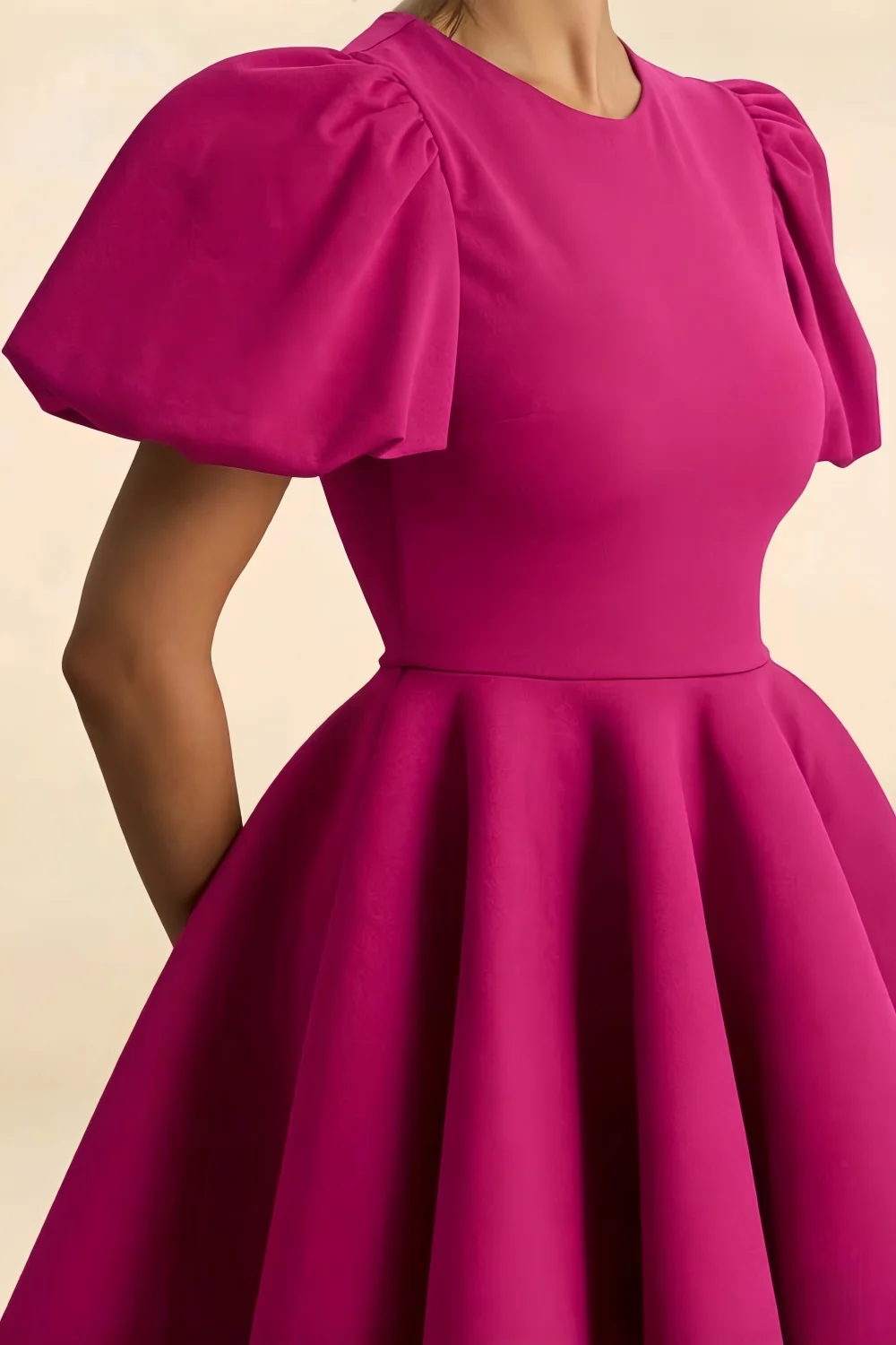 Detailed fabric shot of the LVLVS Celia hot pink stretch crepe mini dress, emphasizing the texture and fit of the puff sleeves.