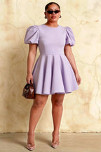Plus size model wearing LVLVS Celia lavender puff sleeve skater dress for curvy women