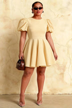 Plus Size Model Wearing LVLVS Celia Lemon Stretch Crepe Dress, Inclusive A-Line Mini Dress with Puff Sleeves Perfect for Curvy Figures at Graduation and Special Events