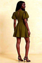 Back view of LVLVS Celia olive crew neck eyelet mini dress featuring puff shoulders and elegant keyhole back zipper detail.